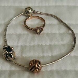Bracelet with 1 silver charm,1 rose gold charm. Rose Gold Ring with stones.